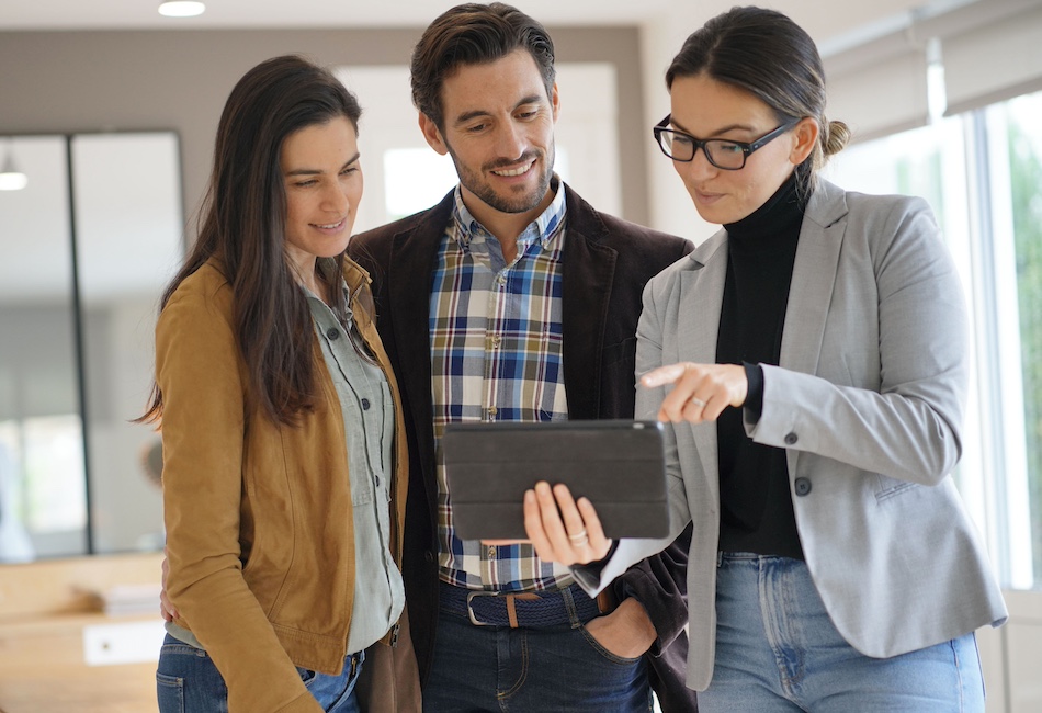 couple looking at property with agent