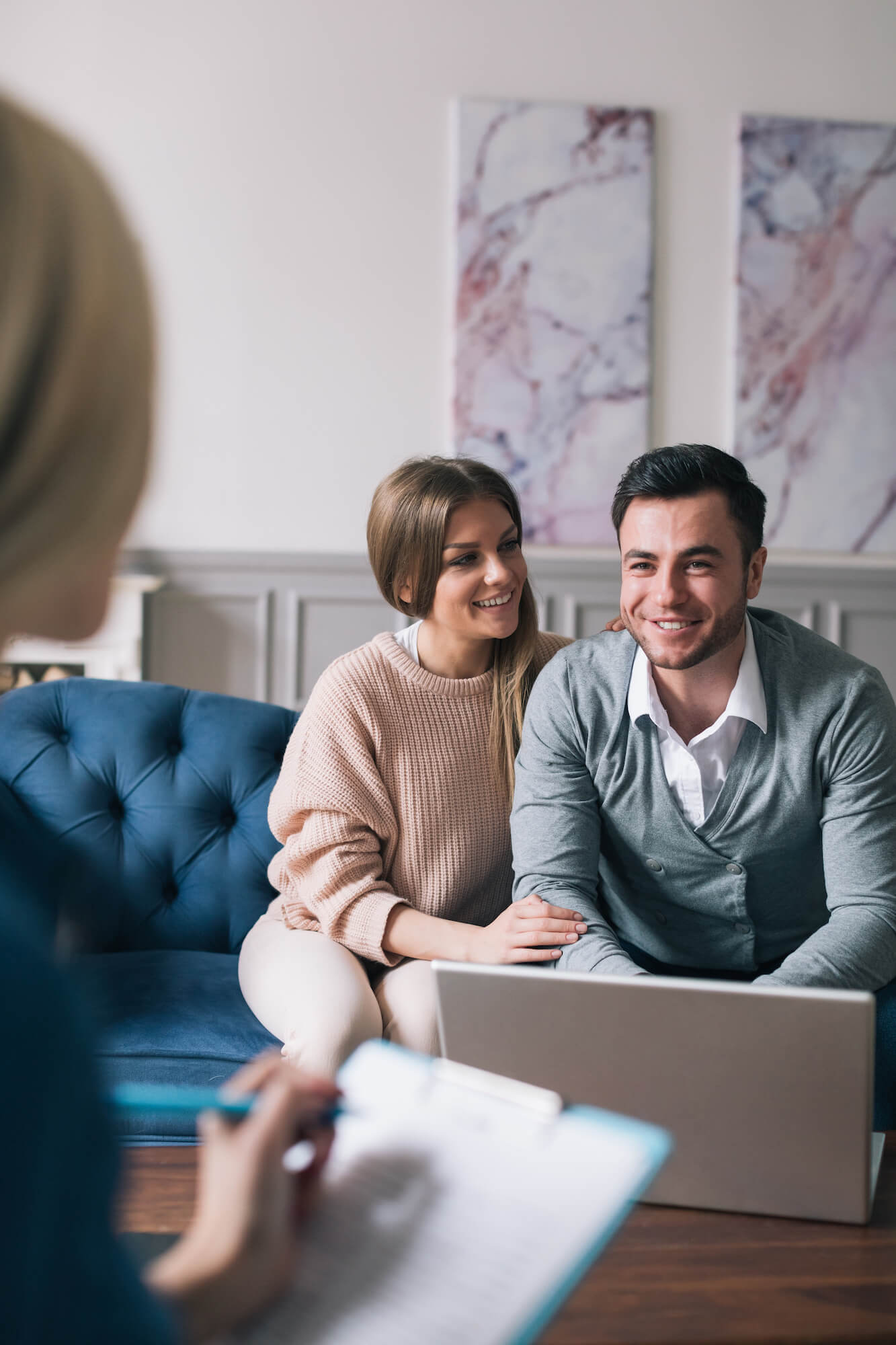 A couple disucssing real estate with their home agent.