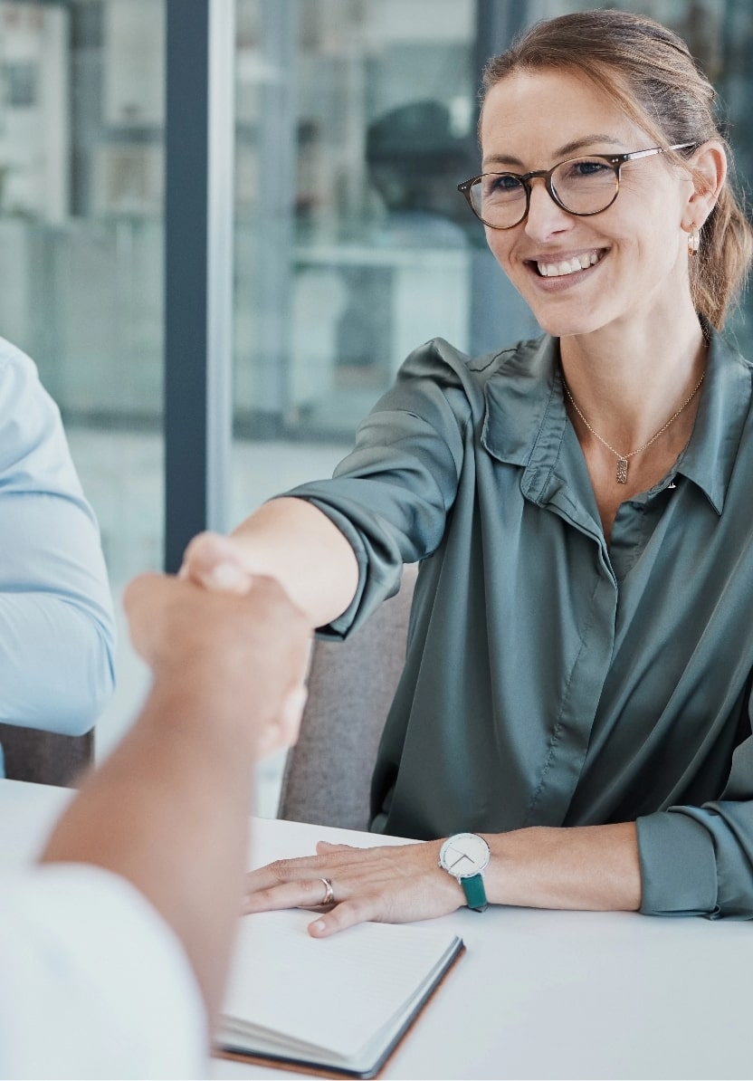 A woman shaking hands with a client