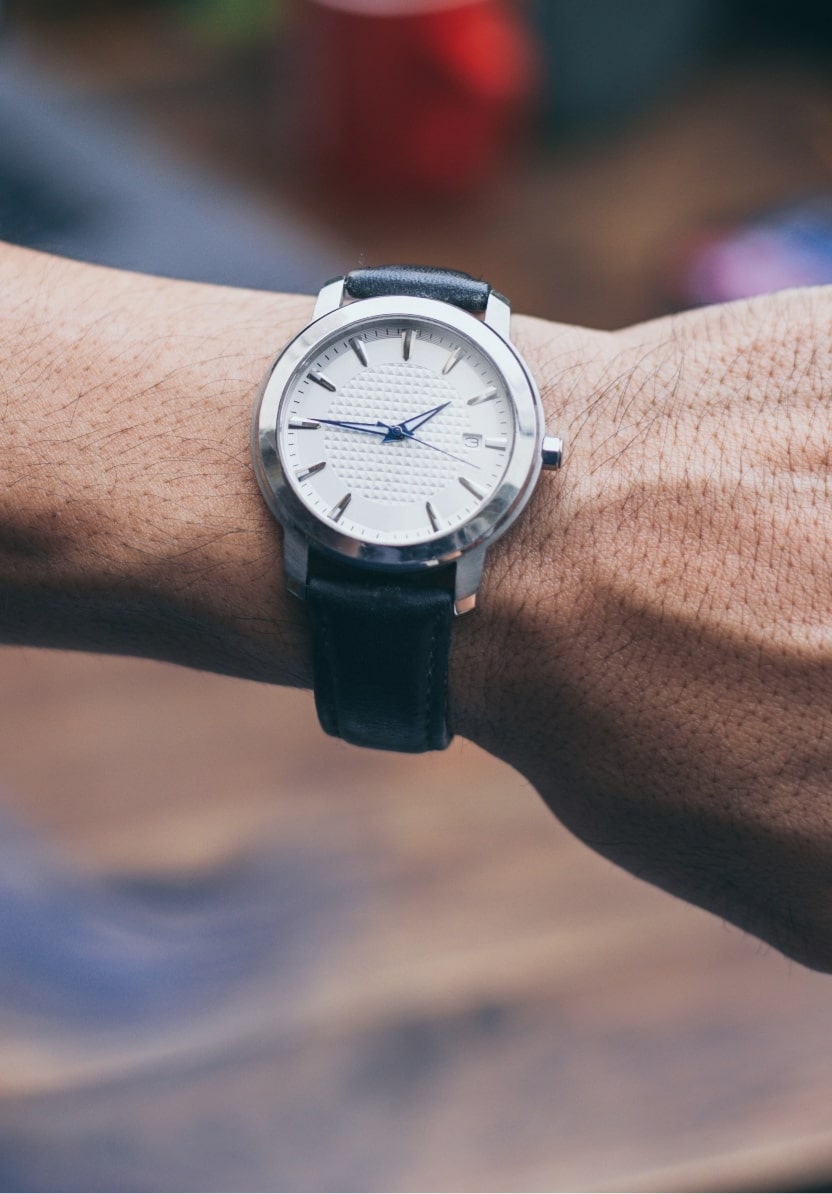 A man's wristwatch on a skinny wrist