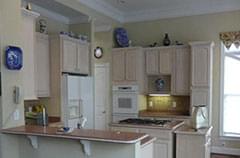 Before: Dark kitchen with salmon-colored countertops
