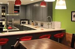 After: Kitchen with modern lighting and seating + color updates