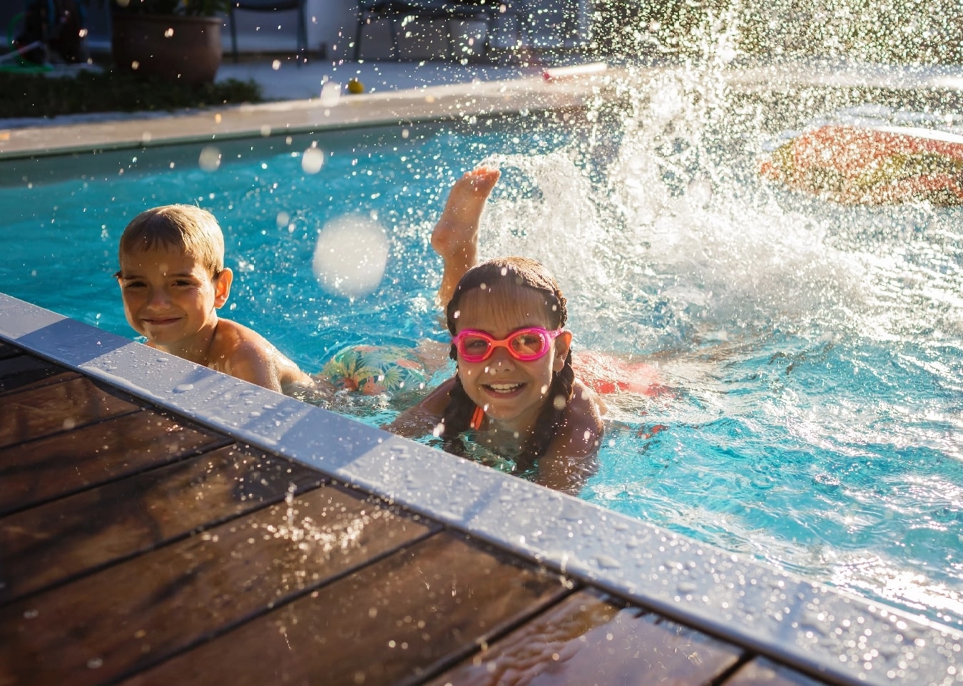 Kids splashing in the backyard pool
