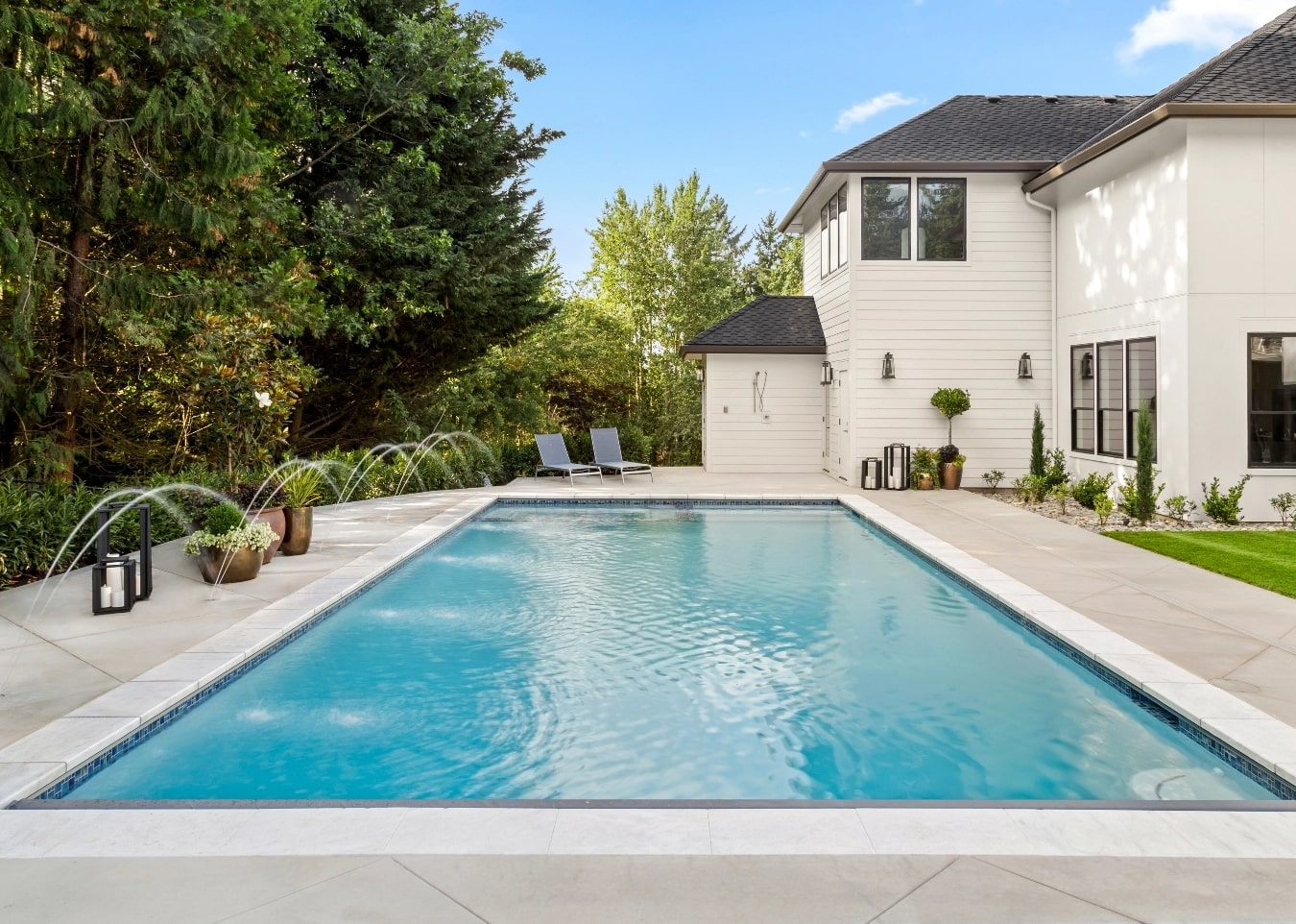 An elegant backyard with an inground pool