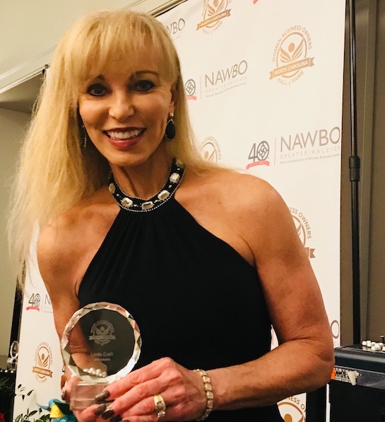 Linda holding award
