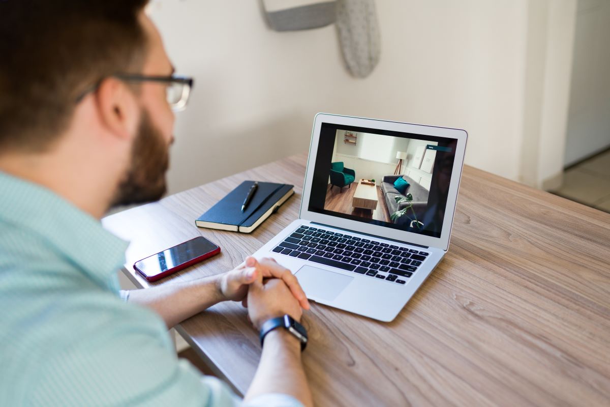 man seeing house tour in computer